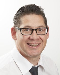 White male with brown hair and glasses.